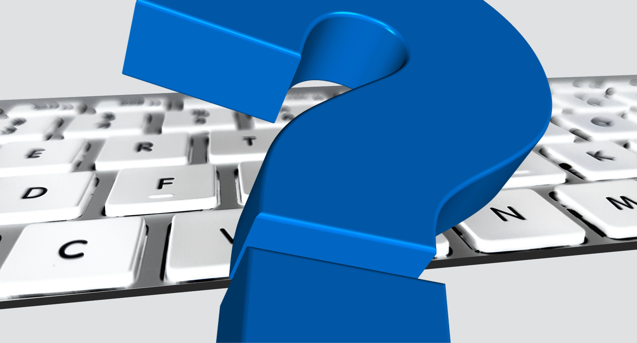 Das Bild zeigt eine Tastatur und ein blaues Fragezeichen.